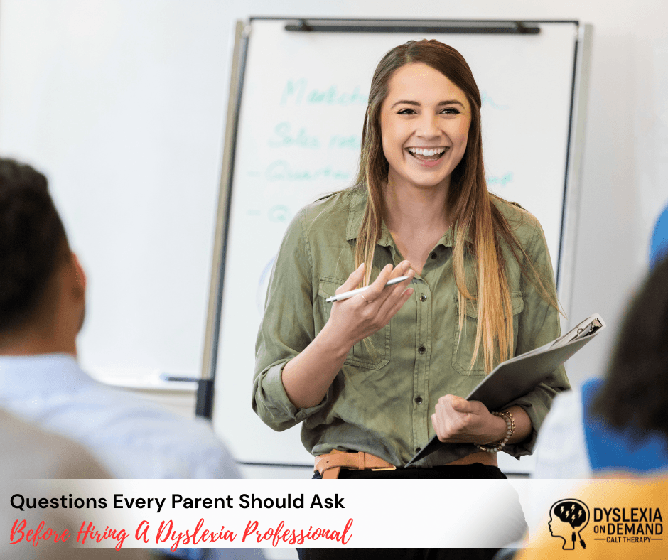 A smiling young woman stands at a whiteboard, holding a clipboard and marker as she leads a discussion. Text reads: Questions Every Parent Should Ask Before Hiring a Dyslexia Professional.