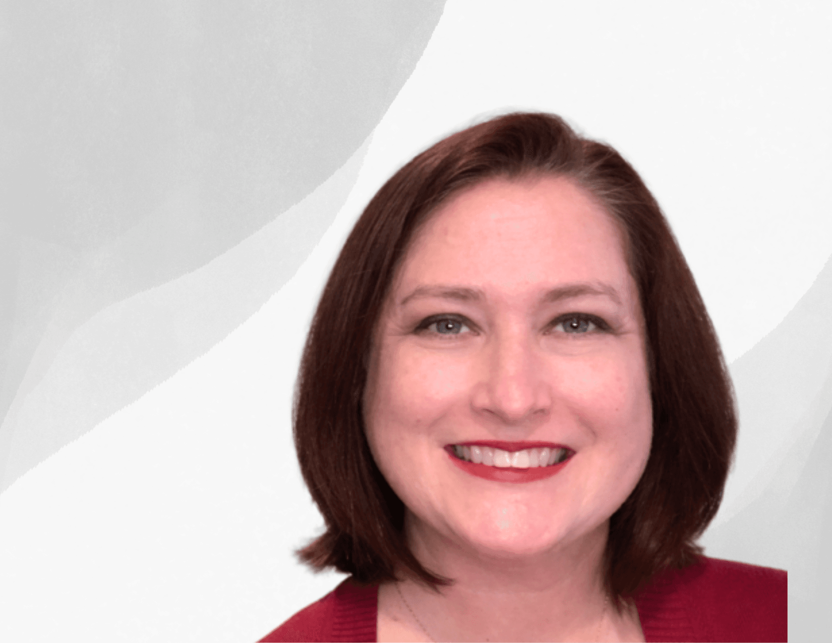 A woman with straight, shoulder-length brown hair smiles at the camera. She is wearing a red top and is set against a light gray and white abstract background.